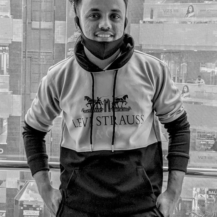 A former hospitality manager turned lead design curator reviewing corporate floral arrangements